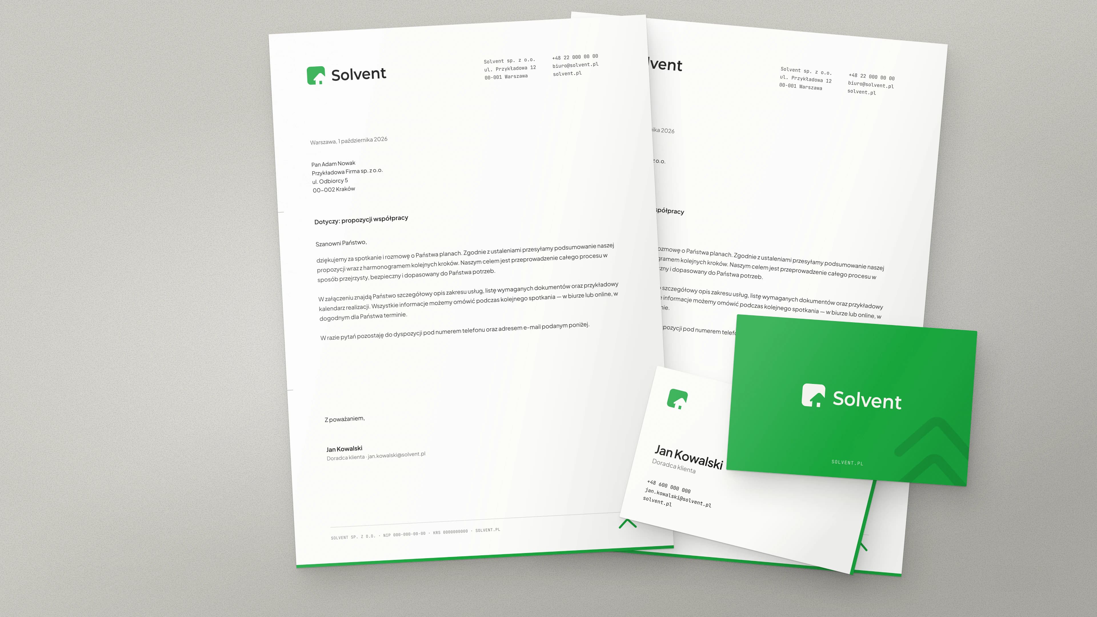Two sheets of Solvent letterhead with a letter, with a white and a green business card on top